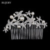 A silver rhinestone bridal hair comb tiara featuring sparkling stones and pearl accents.