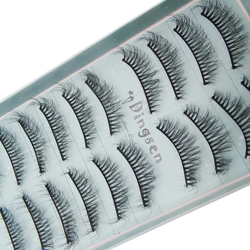 A close-up of a cosmetic palette showing various styles of black mink false eyelashes.