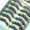 A display of black mink false eyelashes arranged on a light blue surface.
