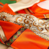 Orange and cream satin silk scarf with gold embroidery and patterned fabric folds