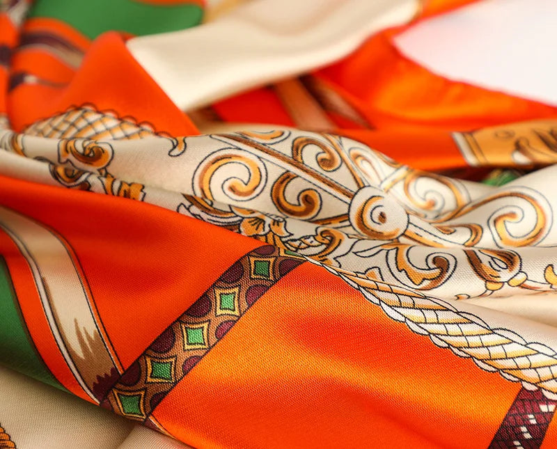 Orange and cream satin silk scarf with gold embroidery and patterned fabric folds