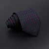 A dark navy blue men's tie with small red polka dots, rolled and displayed on a black background.
