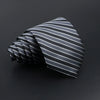 A folded gray and black striped men's tie displayed against a dark background.