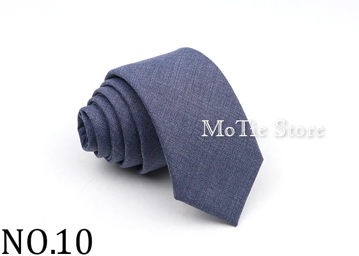 A dark blue solid color tie folded neatly on a white background.