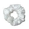 White satin scrunchies tied in a voluminous bow shape