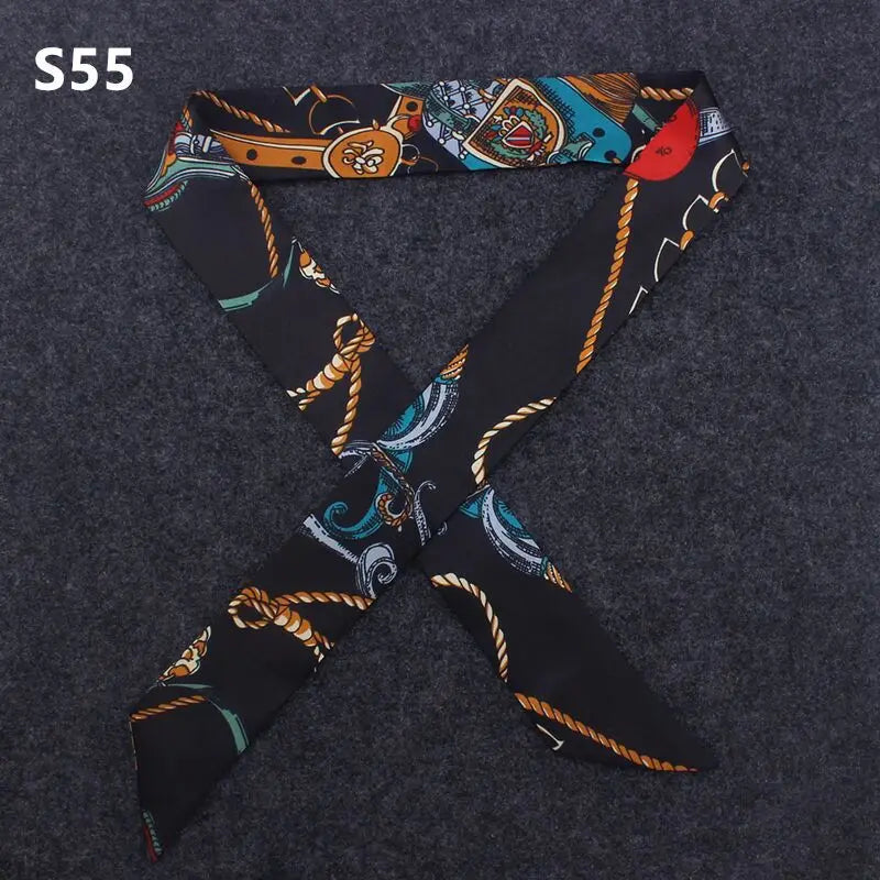 A black silk headband scarf with a multi-color leopard print pattern, shown in an 'X' shape.