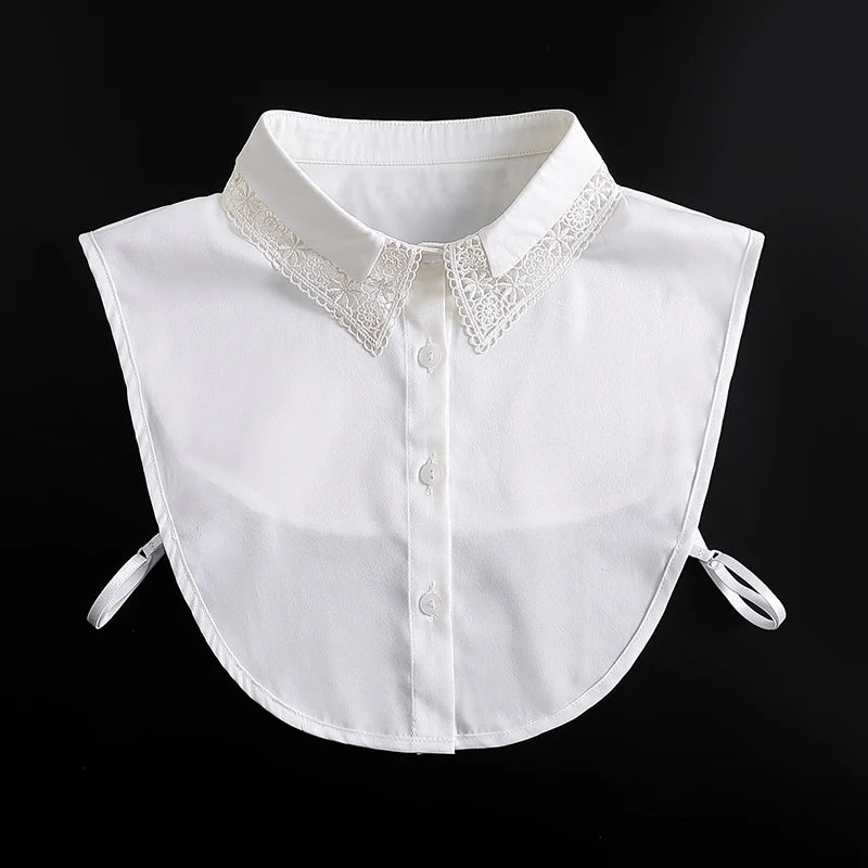 White blouse with a detachable lace false collar neckline and tie closures.