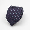 A dark blue necktie with a pattern of small purple and light blue squares and dots.