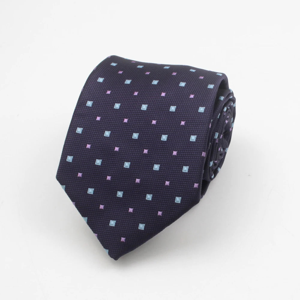 A dark blue necktie with a pattern of small purple and light blue squares and dots.
