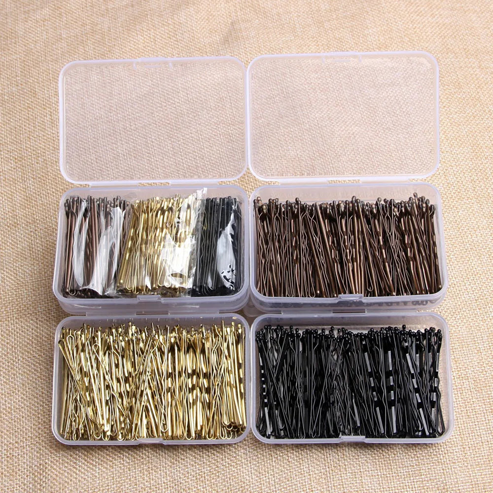 A set of elegant metal hair clips in various colors and finishes packaged in clear plastic containers.