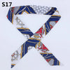 A silk headband scarf featuring a multi-color leopard print design with blue and gray patterns.