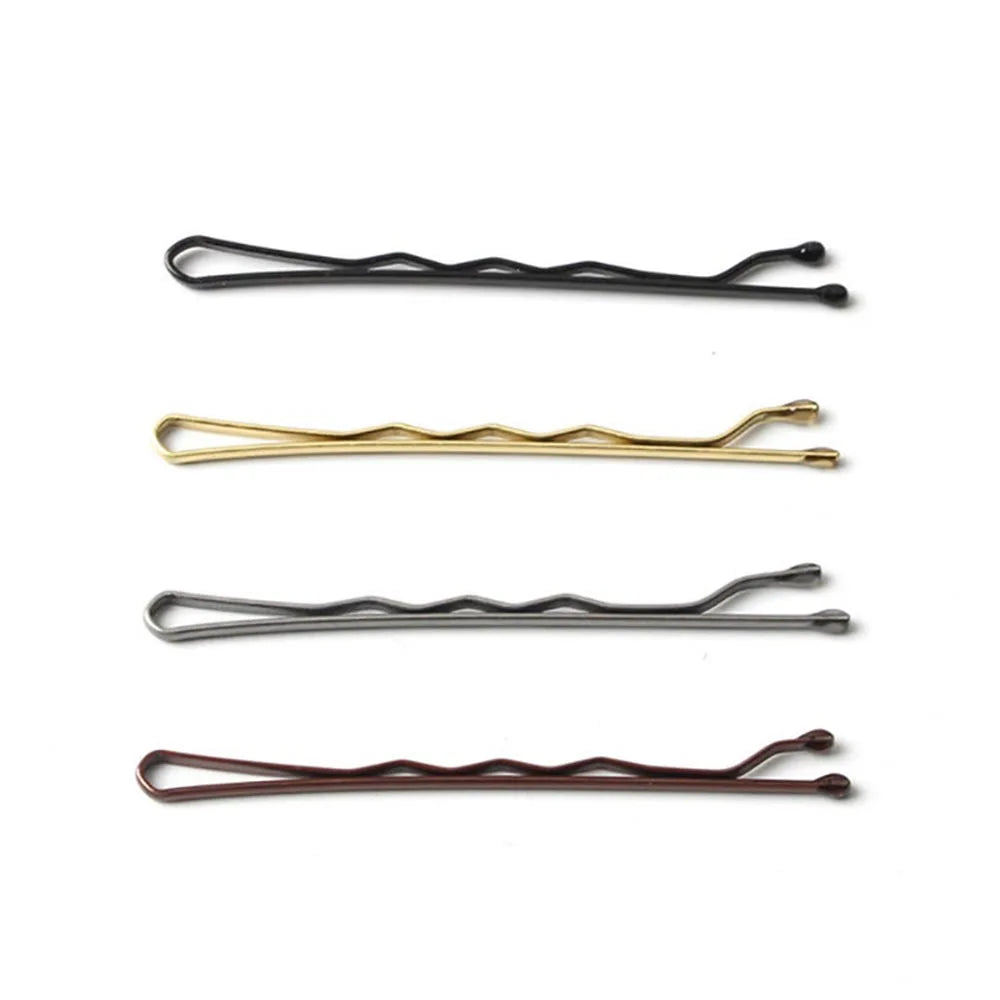 Three metal hair clips in black, gold, and brown for styling