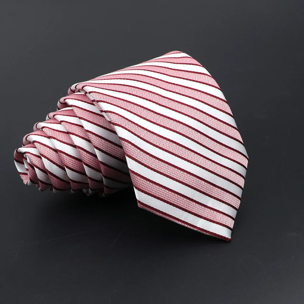 A folded classic men's tie featuring thin red and white diagonal stripes.