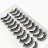 A close-up of dramatic mink false eyelashes applied to a white surface.