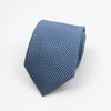 A folded blue patterned necktie with a geometric weave texture.
