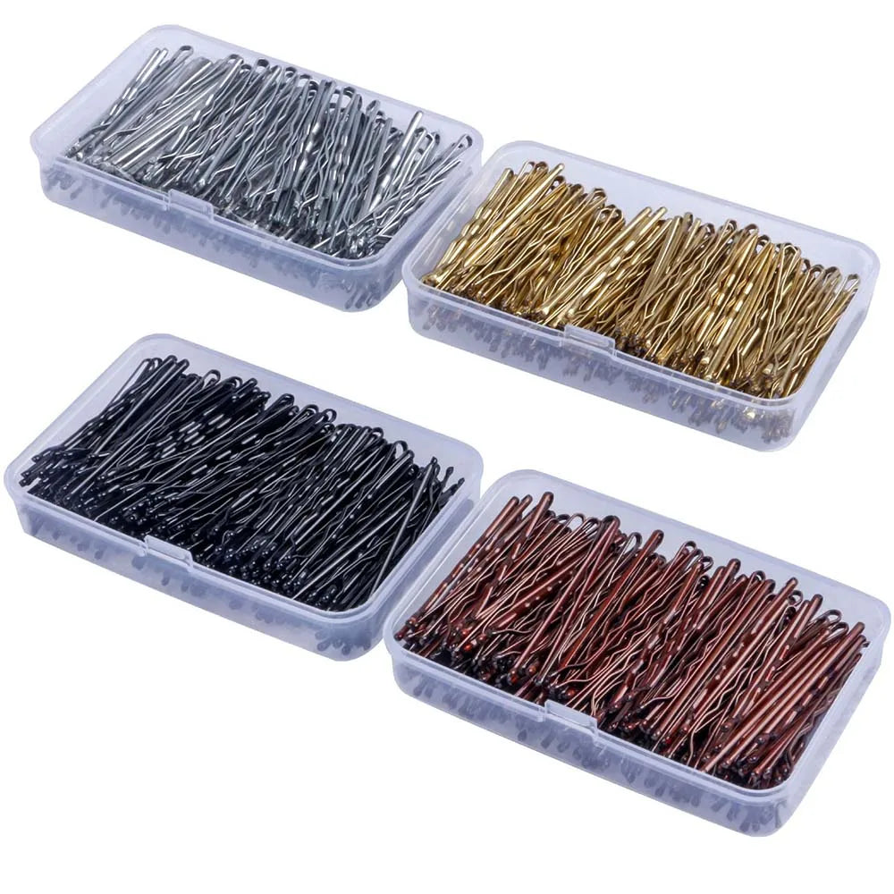 A collection of elegant metal hair clips in silver, gold, black, and copper are displayed in clear plastic containers.