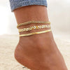 Gold stainless steel anklets worn around a woman's ankle.