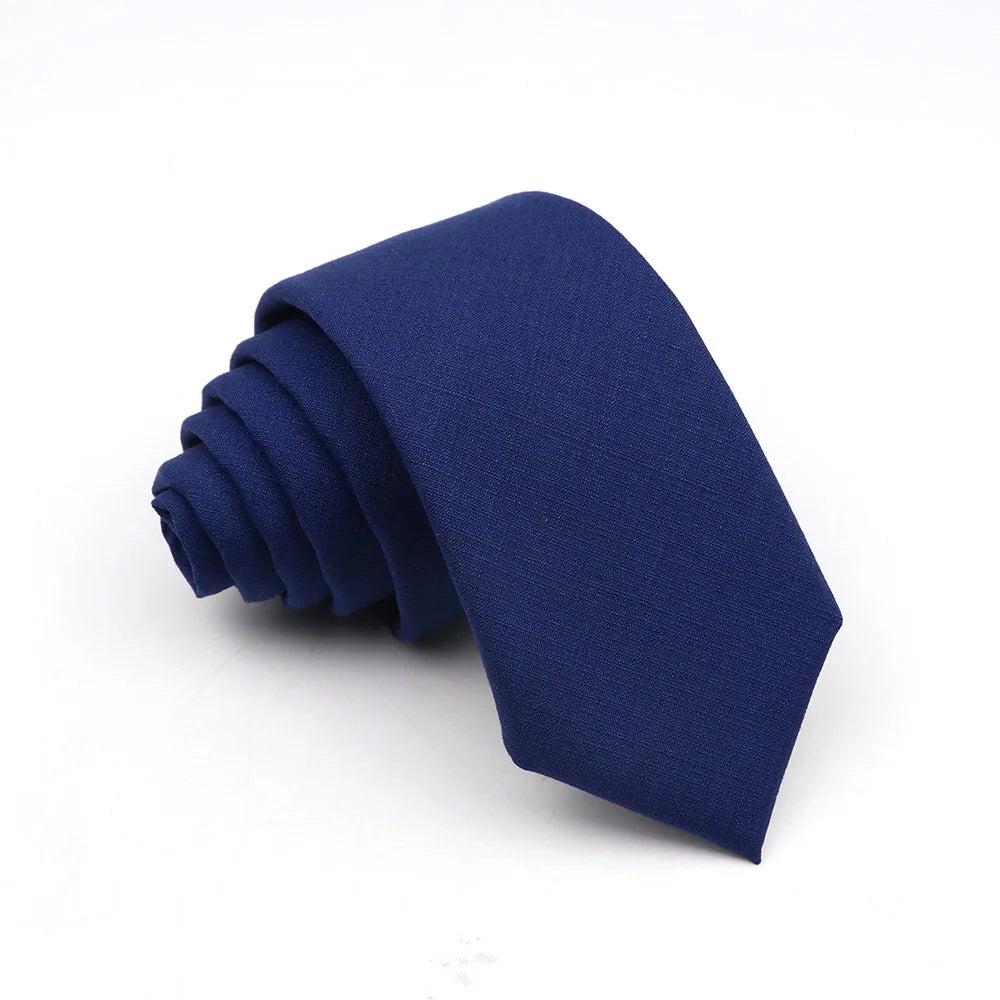 A dark blue men's solid color anti-wrinkle bamboo fiber tie folded neatly.
