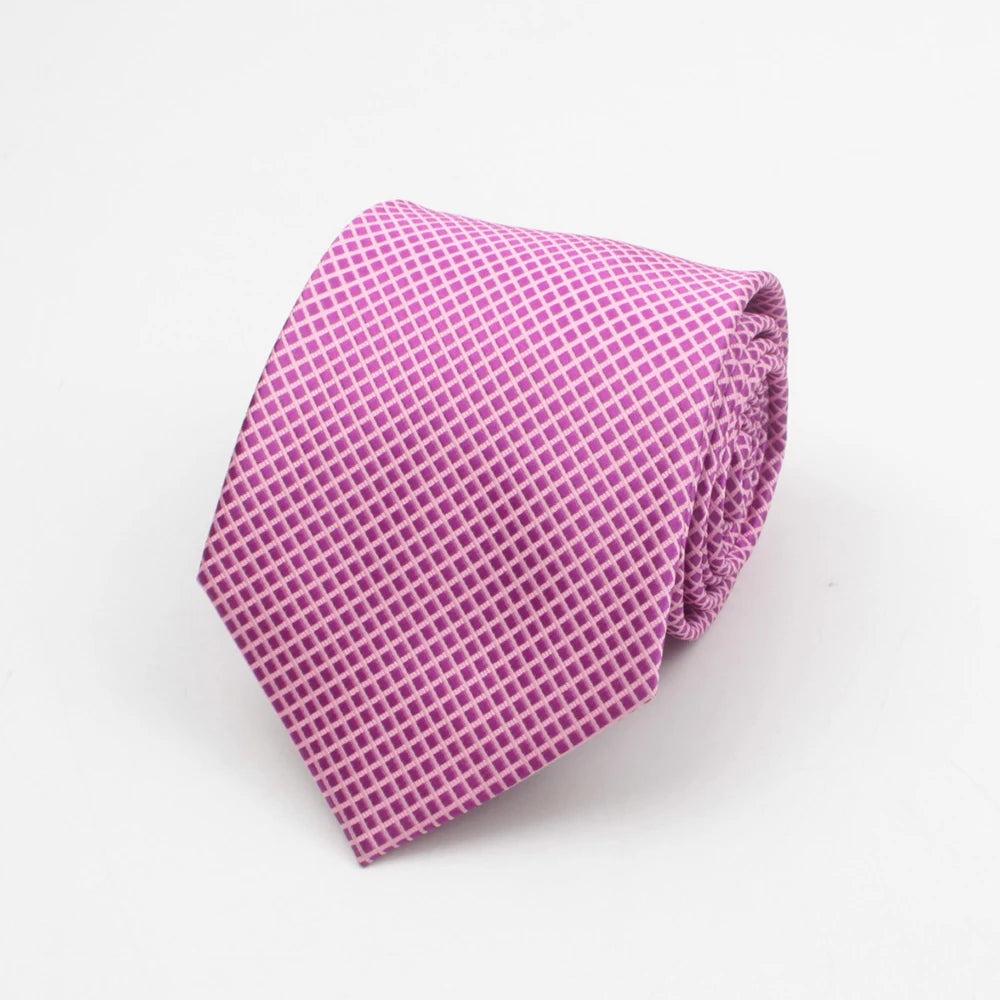 A purple patterned necktie folded neatly on a white background.