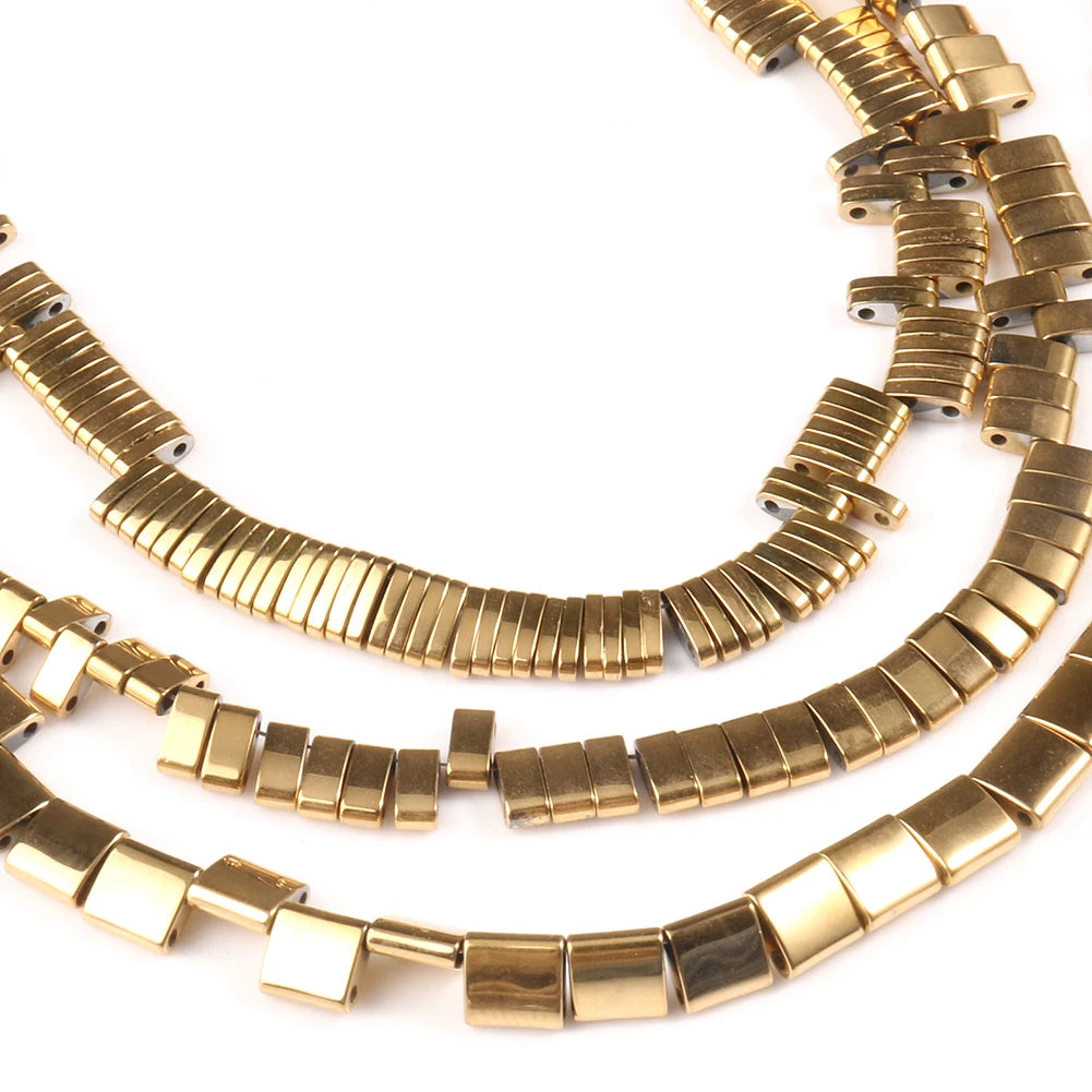 A close-up of gold-plated hematite round cube beads arranged in multiple strands for DIY jewelry making.