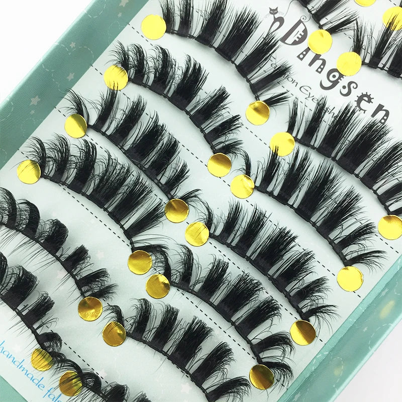 A display of black 3D mink false eyelashes on a light green background.