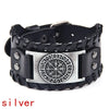 Black leather bracelet with a silver compass design and studs.