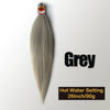 A bundle of grey pre-stretched Kanekalon braiding hair extensions with a heat setting label visible.