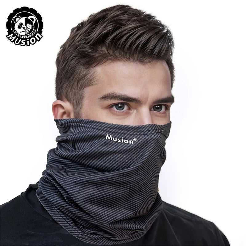 A man wearing a gray Musion mask scarf covering his lower face.