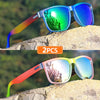 A pair of gradient square frame polarized sunglasses with vibrant green and blue lenses resting on a rock.