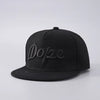 Black unisex luxury baseball cap with the word dope embroidered on the front