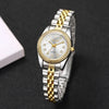 A silver and gold rhinestone quartz wristwatch with a metal bracelet is shown on a dark background.