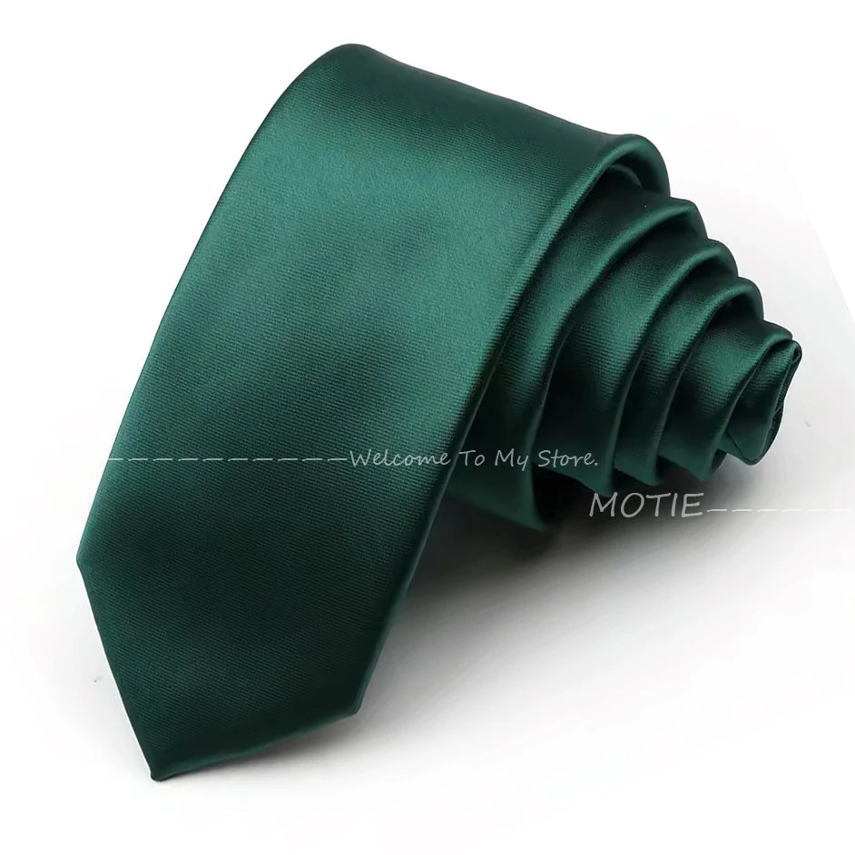 A dark emerald green satin neck tie folded and displayed on a white background.