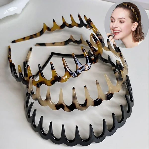 A set of black and amber fashion acetate toothed headbands displayed on a white background.
