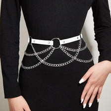Black ribbed long-sleeve top worn by a model, featuring an adjustable faux leather harness belt.
