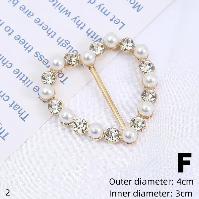 Gold-toned button clips featuring a decorative border of white pearls and clear rhinestones.