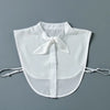 White sheer blouse with a false collar and detachable neckline, displayed flat.