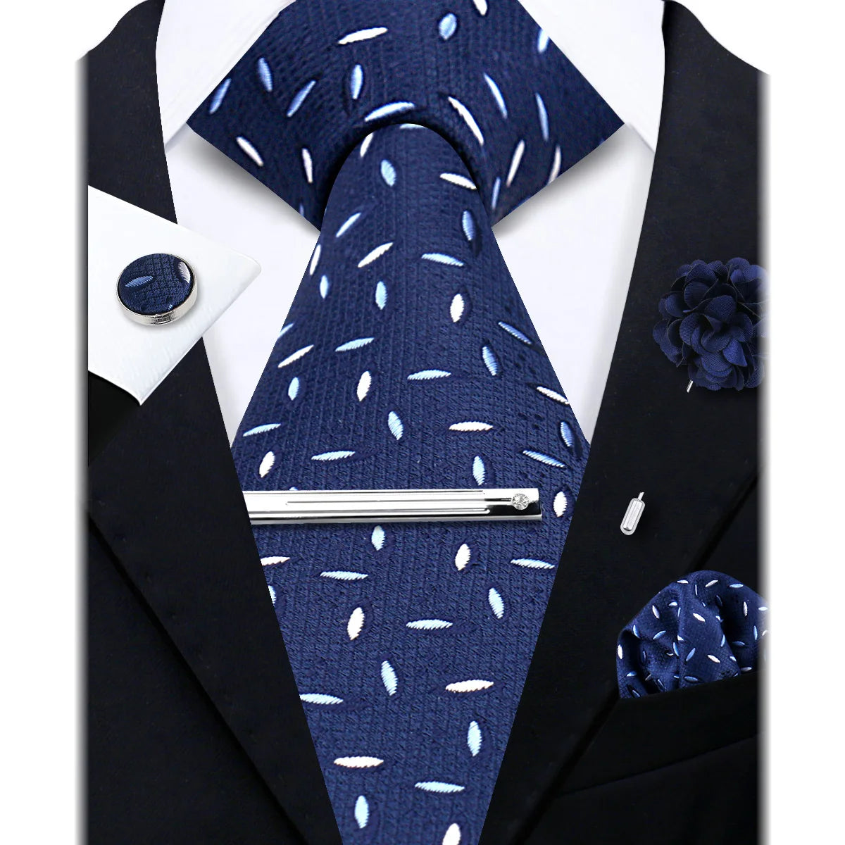 A dark blue patterned necktie and a dark blue floral lapel pin displayed against a black suit jacket.