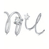 Aretes de aro dobles plateados con dije de estrella y piedra redonda tallada en diamante.