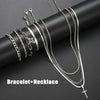 A collection of silver stainless steel bracelets and necklaces featuring cross designs displayed on a dark background.