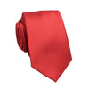 A red slim jacquard business tie rolled and displayed against a white background.