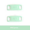 A pair of light mint green diamond shoe charms with the letters AFI stamped on them.