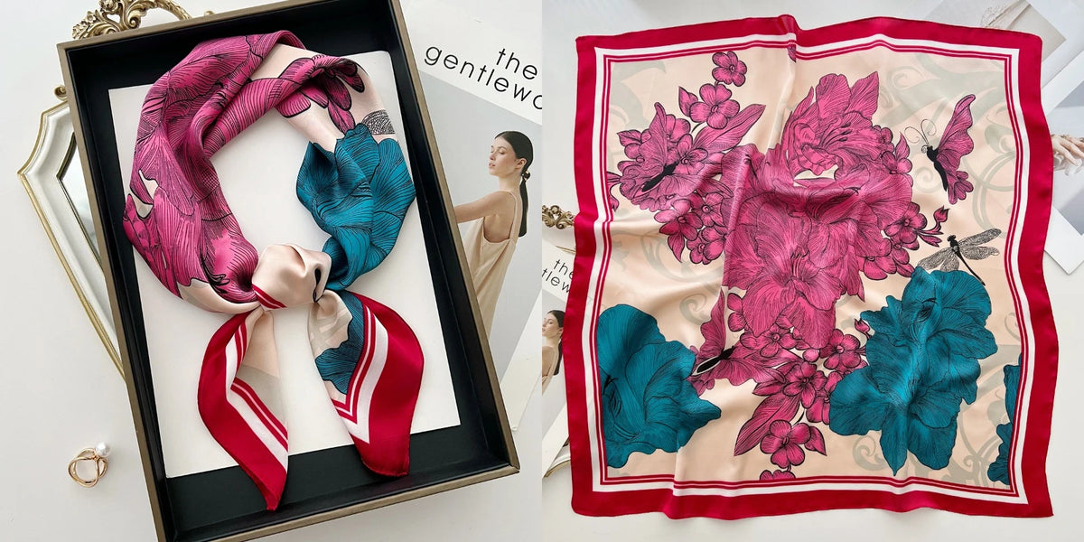 A pink floral print silk scarf draped in a black frame, featuring vibrant pink and teal hues.