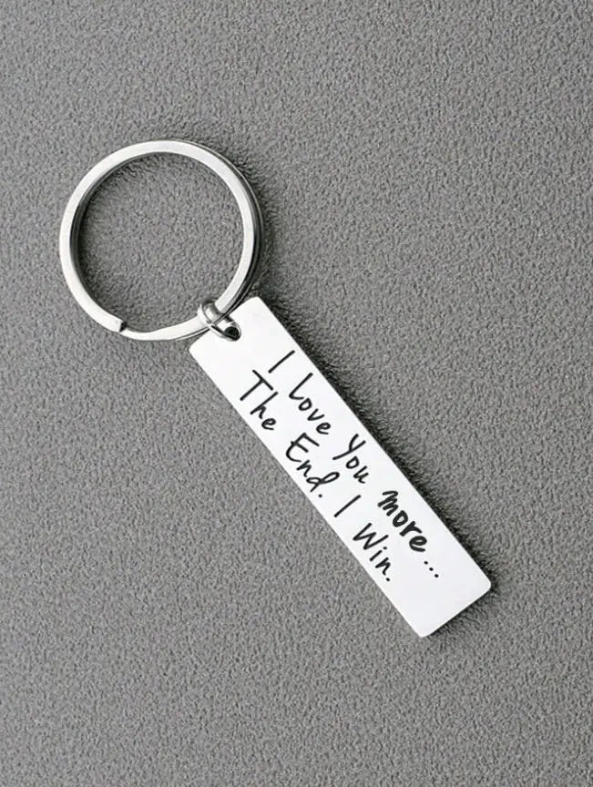 Silver keychain with a rectangular tag engraved 'I Love You more I Win.'