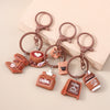 A set of brown leather coffee-themed keychains featuring cups, coffee pots, and heart shapes.