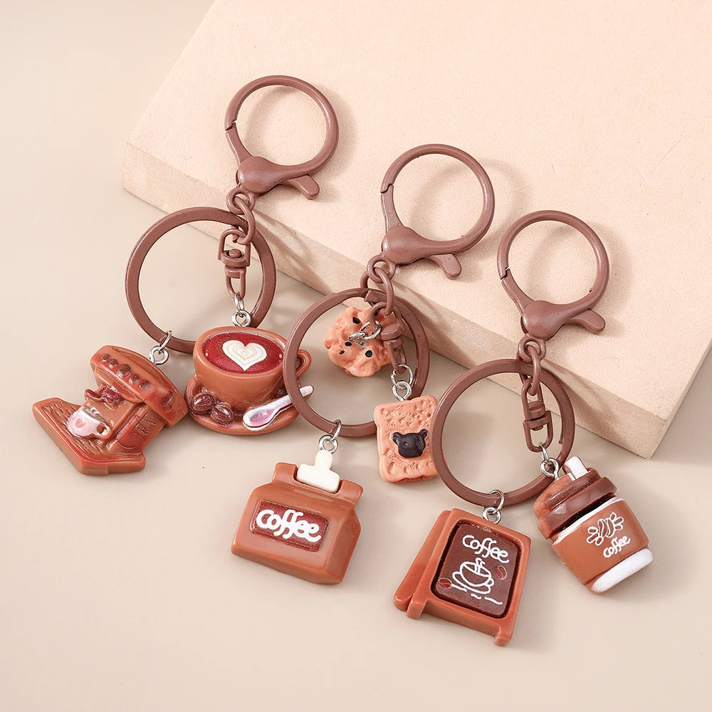 A set of brown leather coffee-themed keychains featuring cups, coffee pots, and heart shapes.