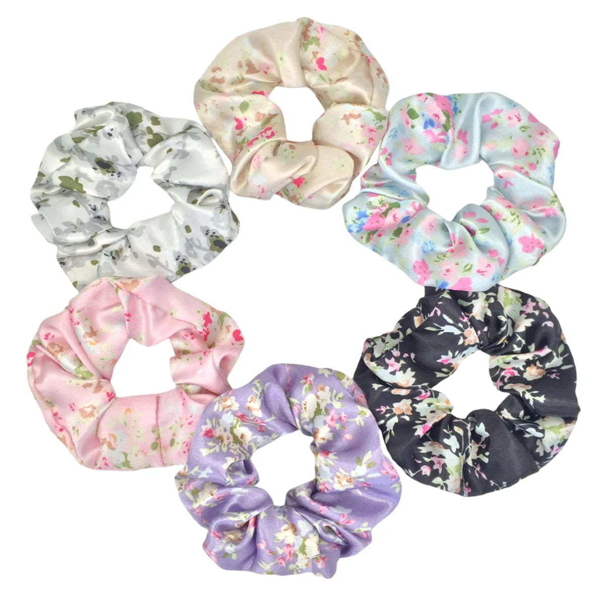Un juego de seis moños de satén con varios estampados florales, incluyendo blanco, rosa, azul y morado.