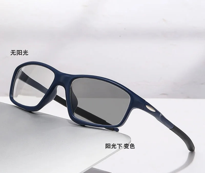 A pair of dark blue photochromic reading glasses resting on a white surface.