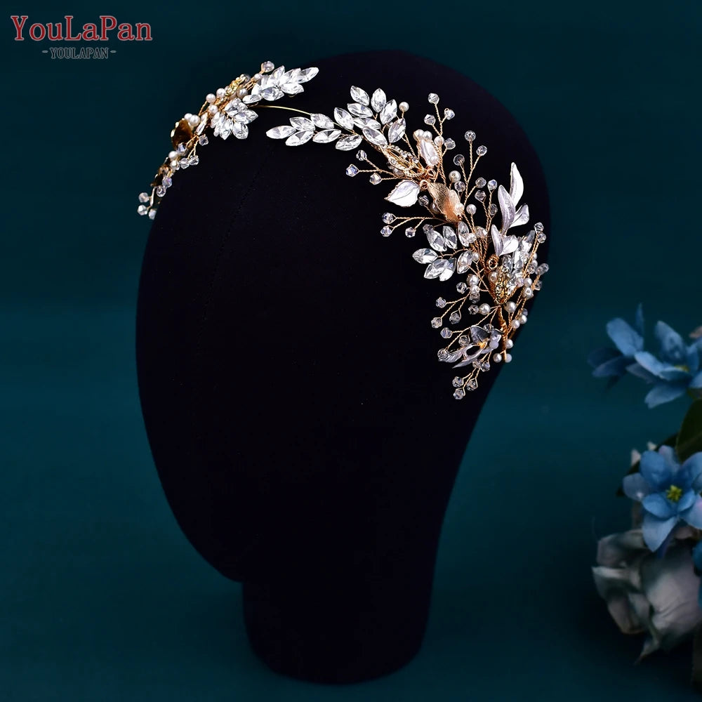 A handmade crystal bridal headband with gold accents displayed on a black mannequin head.
