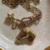 Gold plated butterfly key pendant charm hanging from a gold chain