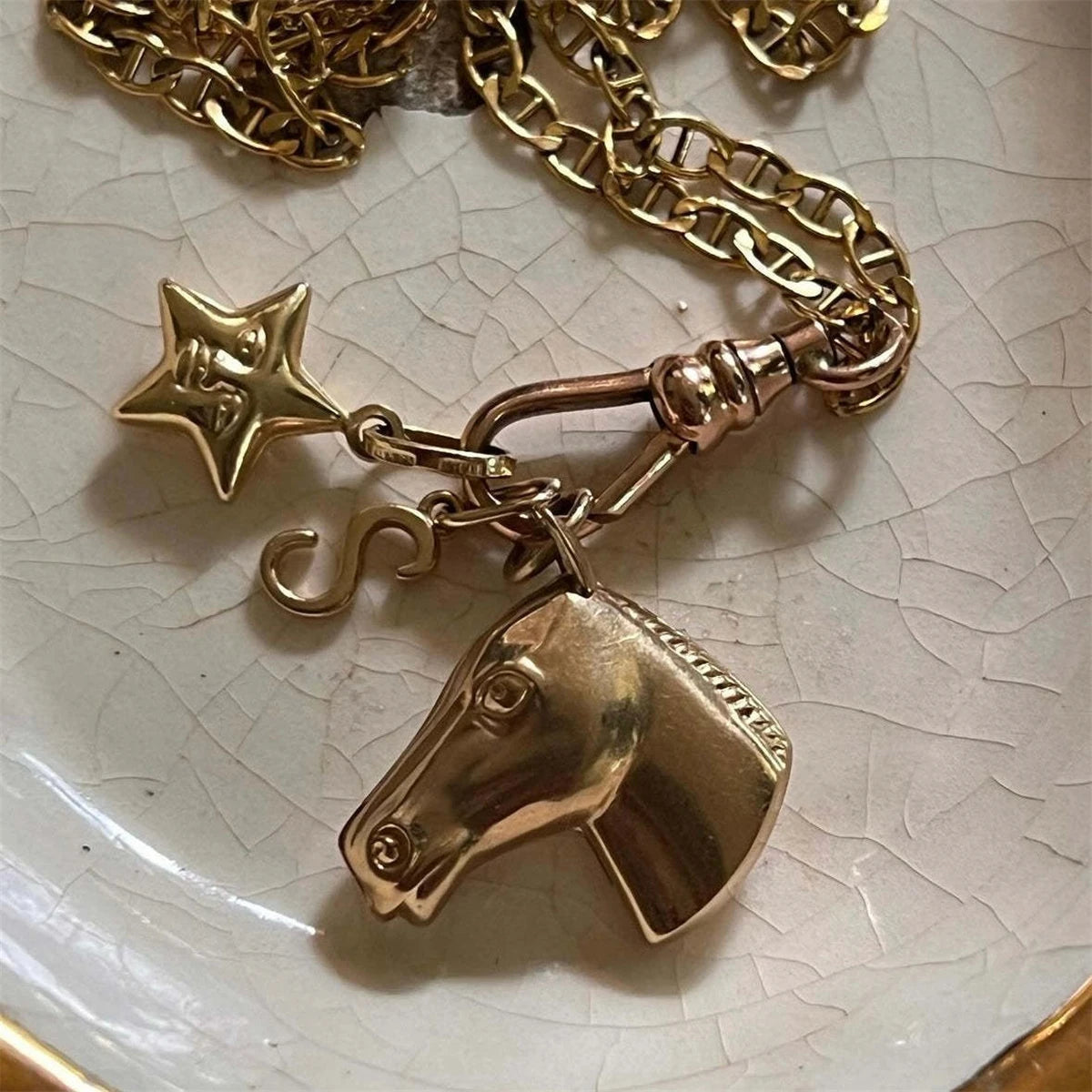 Gold plated butterfly key pendant charm hanging from a gold chain